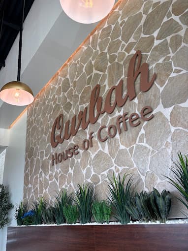 Qurbah House of Coffee signage inside the shop